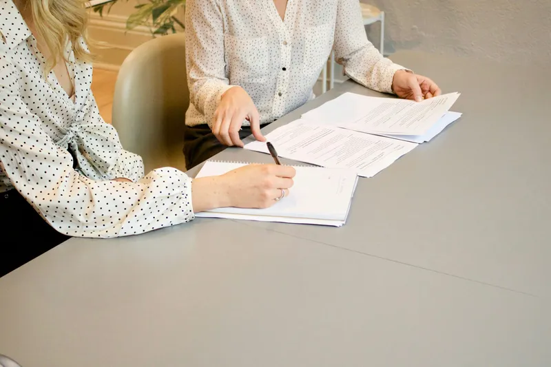 Personne signant un document à un bureau